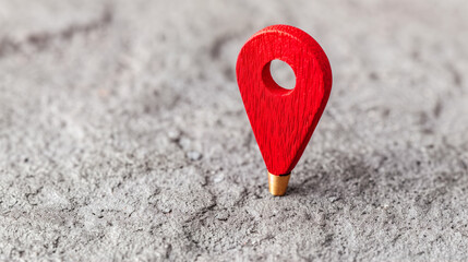 Poster - Map pin on a textured surface red color highlighting location travel planning and navigation concept