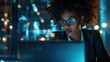 © Ruslan Gilmanshin - A woman wearing sunglasses is using a laptop at night during evening hours