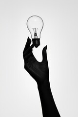Poster - A conceptual image of an abstract hand holding a light bulb in the middle of the image