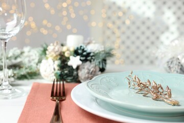 Canvas Print - Christmas place setting with plates, fork and festive decor on table, closeup