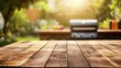 © Nuttaya Nampai - A clean wooden table with a blurred BBQ grill in the background, suggesting a vibrant outdoor cooking scene, ideal for food and outdoor lifestyle themes.