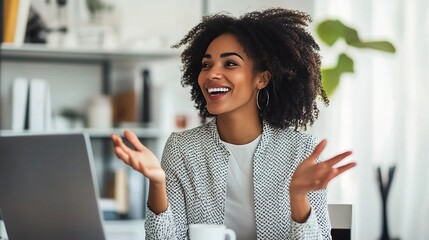 Poster - A cheerful woman with curly hair is engaged in a conversation at her laptop, showcasing a lively home office environment.