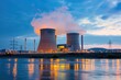 © Alena - A large industrial power plant with visible smoke emitting from the stacks, suitable for use in illustrations about energy production or environmental issues