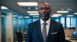 © Arceli - Focused middleaged Black man wearing a business suit in a corporate office