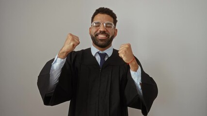 Wall Mural - Judge, young hispanic man in gown standing as a winner, happy and excited for success with gestures and screams over isolated white background