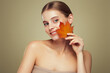 © Oleg Gekman - Portrait of beautiful young woman with autumn leafs. Healthy clean fresh skin natural make up beauty eyes