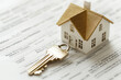 © anzodesign - House key and miniature home model on a property document, symbolizing new beginnings