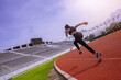 © Panumas - Fit young woman running sprinting at the racetrack. Fit runner fitness runner during outdoor workout at racetrack.