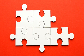 Sticker - White puzzle pieces on red background, top view