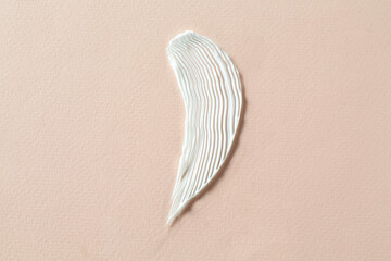 Poster - Smear of cosmetic product on beige background, top view