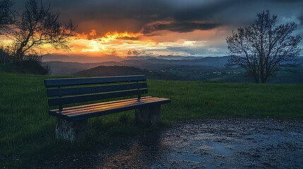 Sticker - A lone bench sits on a grassy hill overlooking a valley, bathed in the golden glow of a dramatic sunset.