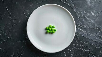 diet concept. one pea on an empty white plate with knife and fork