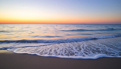 Poster - A tranquil stock photo of an empty beach with gentle waves lapping against the shore at sunset.	
