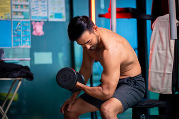 A strong Asian man is exercising to build muscle..