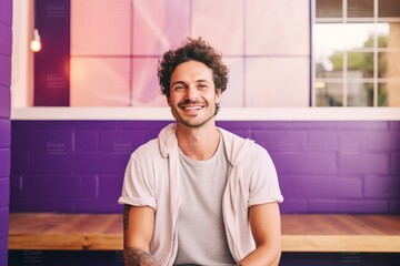 Canvas Print - Portrait of a cheerful man in his 30s wearing a chic cardigan in vibrant yoga studio background