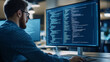 © Kevin - Computer Programmer Writing Code on a Large Monitor