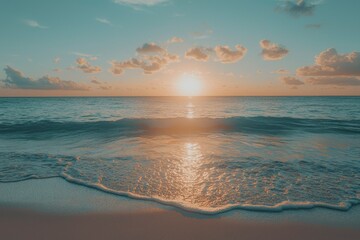 Wall Mural - A Gentle Wave Rolling Onto a Sandy Beach at Sunset