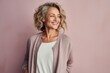 © Markus Schröder - Portrait of a jovial woman in her 40s wearing a chic cardigan in pastel or soft colors background