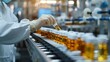 © alauli - Pharmaceutical factory worker in white coat and gloves inspecting medicine bottles on conveyor belt