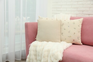 Poster - Decorative pillows and fluffy blanket on pink sofa indoors