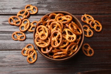 Wall Mural - Tasty pretzel crackers on wooden table, top view