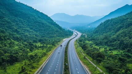 Poster - A scenic view of a long stretch of motorway winding through mountains, with lush greenery on either side, showcasing the beauty of road travel.