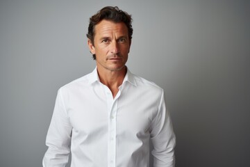 Poster - Portrait of a blissful man in his 40s wearing a classic white shirt in front of minimalist or empty room background