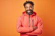 © Markus Schröder - Portrait of a glad afro-american man in his 40s wearing a windproof softshell in front of solid pastel color wall