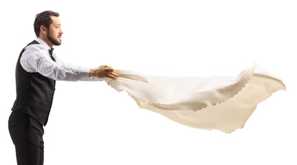 Waiter spreading a tablecloth