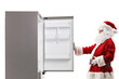 © Ljupco Smokovski - Santa Claus opening an empty fridge