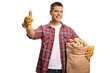 © Ljupco Smokovski - Young farmer holding potatoes in a sack and gesturing thumbs up
