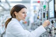 © Downloads - Professional Woman in White Coat Intently Monitoring Complex Industrial System Performance
