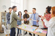 © Studio Romantic - Happy smiling company employees making deal in modern office shaking hands. Business people rejoicing at a successful partnership with a colleagues applauding them on a meeting indoors.