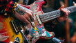 © Евгений Архипов - A medium close-up of hands holding an electric guitar with colorful stickers and wear marks, reflecting an alternative punk rock style.