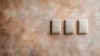 ©  Shomixer - This image showcases three identical light switches mounted on a textured wall, featuring beige and brown tones, representing modern home or office electrical installations.