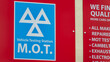 © WD Stock Photos - MOT Vehicle Testing Station Sign on a Red Background