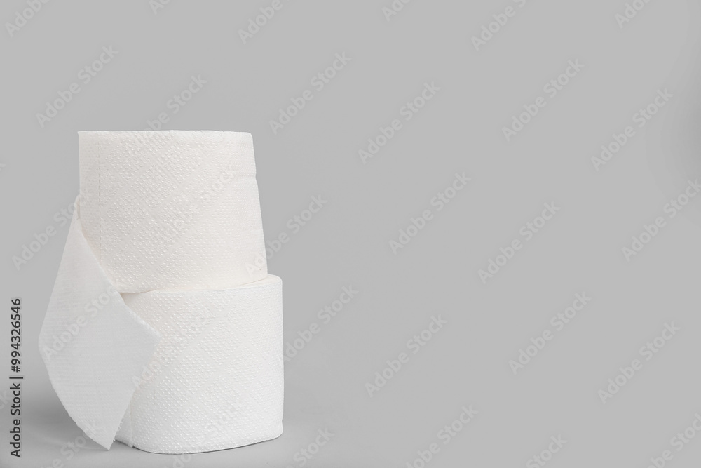 Rolls of toilet paper on grey background