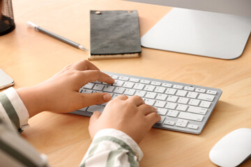 Poster - Female programmer typing on computer keyboard in office, closeup