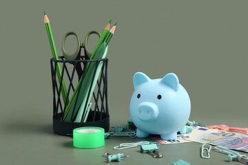 Wall Mural - Piggy bank, money and holder with different school stationery on green background