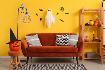 Canvas Print - Interior of living room decorated for Halloween with sofa and shelf unit