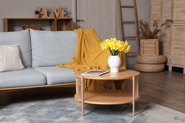 Canvas Print - Interior of stylish living room with grey sofa, plaid, coffee table and flowers