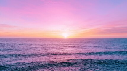 Fototapete - The ocean is calm and the sky is a beautiful shade of pink. The sun is setting, casting a warm glow over the water