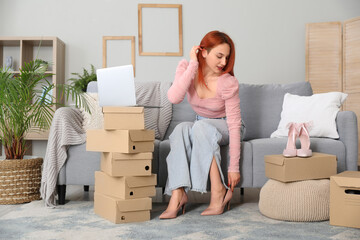 Sticker - Young woman trying on new shoes at home