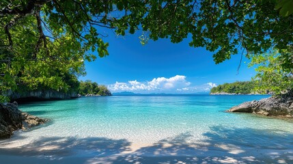 Aufkleber - A beautiful beach with a clear blue ocean and a lush green forest in the background. The sky is clear and the sun is shining brightly. The scene is peaceful and serene