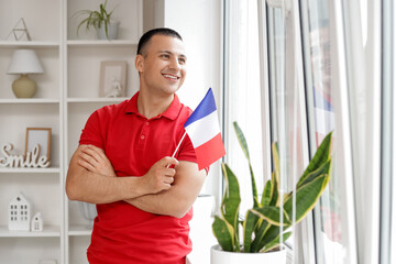 Wall Mural - Young man with flag of France at home