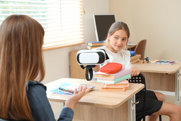 Sticker - Teenage girl showing VR glasses to her classmate in classroom