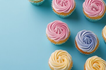 Colorful cupcakes arranged neatly against a light blue background showcasing sweet treats