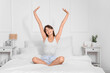 © Pixel-Shot - Morning of beautiful young woman stretching in bedroom