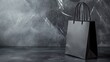 © ArtCookStudio - Simple black shopping bag on a dark marble surface, ideal for retail promotions and branding