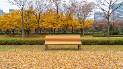 A wooden bench sits alone on a carpet of yellow leaves in a serene park during autumn. The vibrant colors and peaceful atmosphere invite moments of reflection